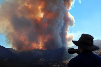 The LA Times published this photo of me photographing the aerial firefight at the Falls Fire above Lake Elsinore in 2013.  © Lee Reeder